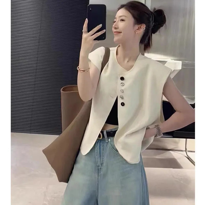 Women's loose fit polyester vest with pockets in milky white colour showing front view