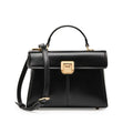 Black leather women's shoulder bag with vachette clasp showing square shape and adjustable strap.