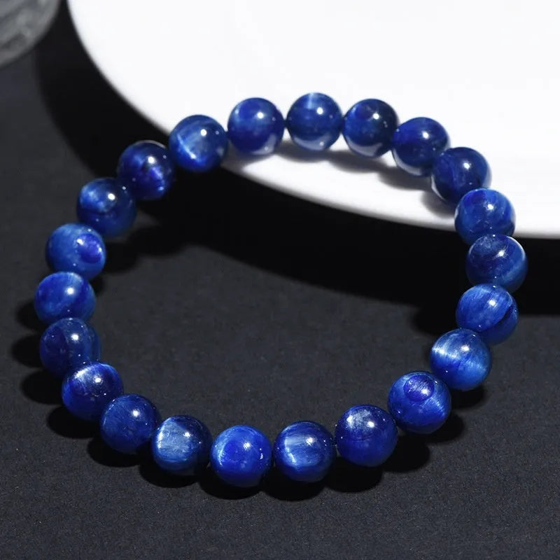 Polished blue crystal bracelet with geometric shapes and ruyi design elements on wrist