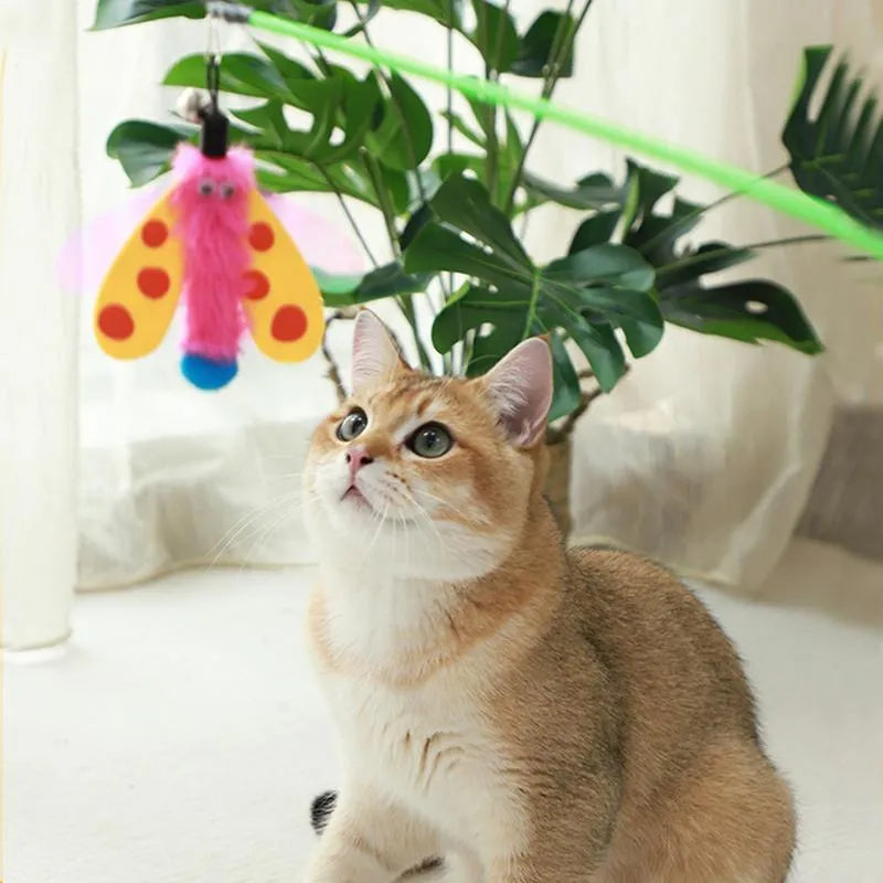 Cat wand toy with bell dragonfly attachment in green, yellow, and pink on white background