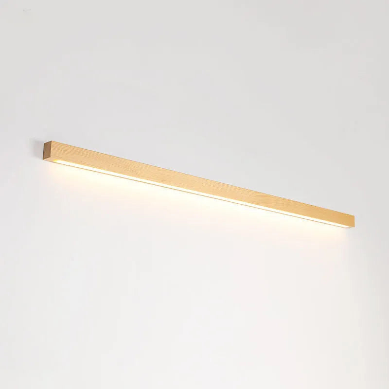 Modern walnut-colour wooden log strip LED wall lamp mounted on a wall.