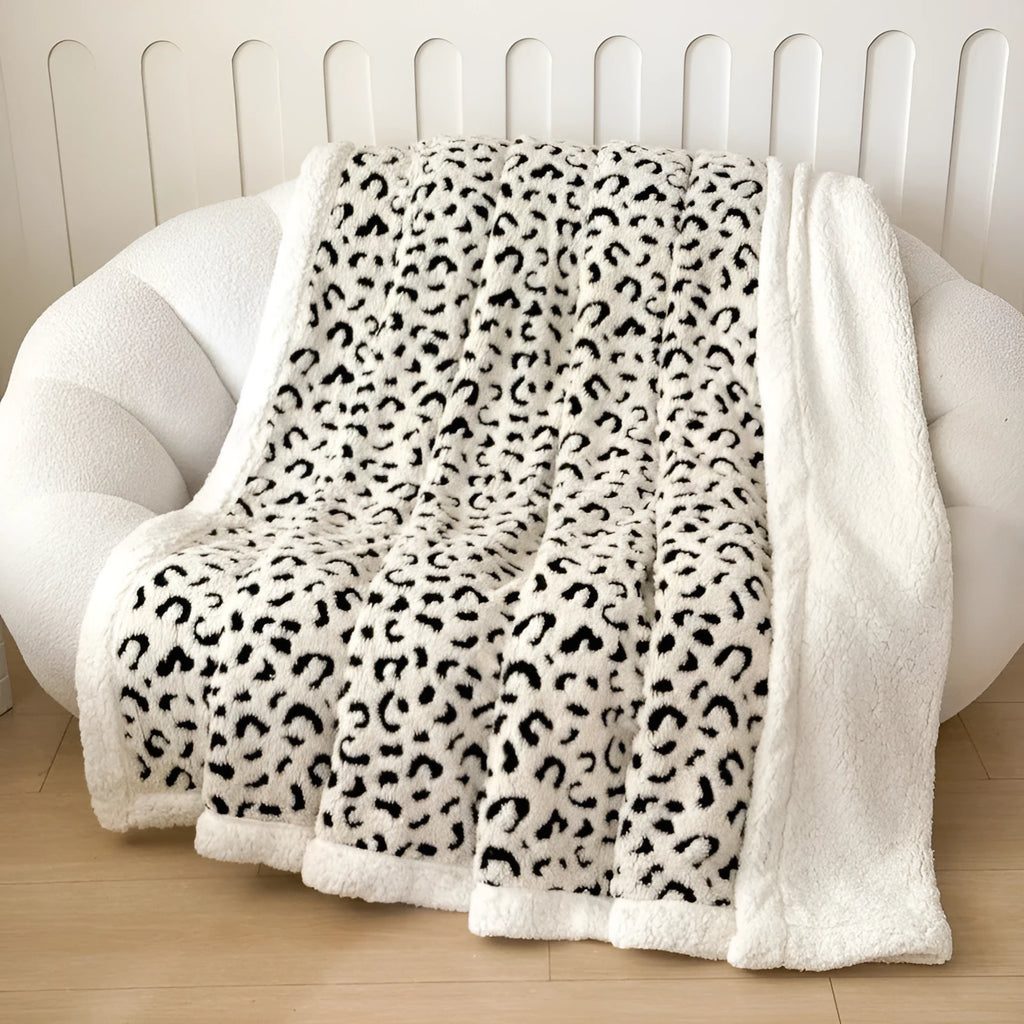 Double-layer cationic jacquard leopard print taffeta blanket in camel colour, folded to show texture.