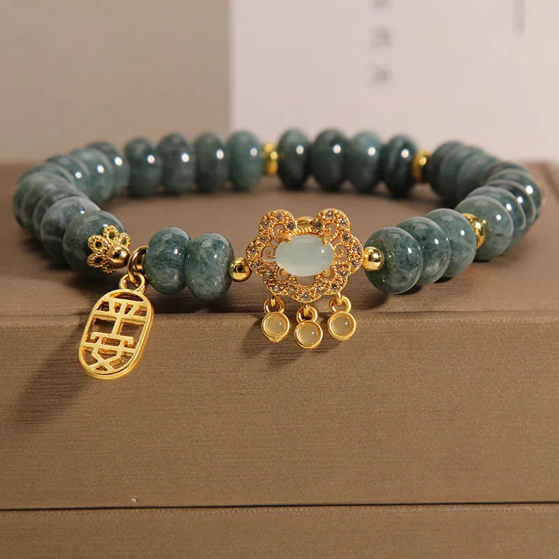Natural emerald jade bracelet for women with abacus beads and a safety lock clasp on a white background.