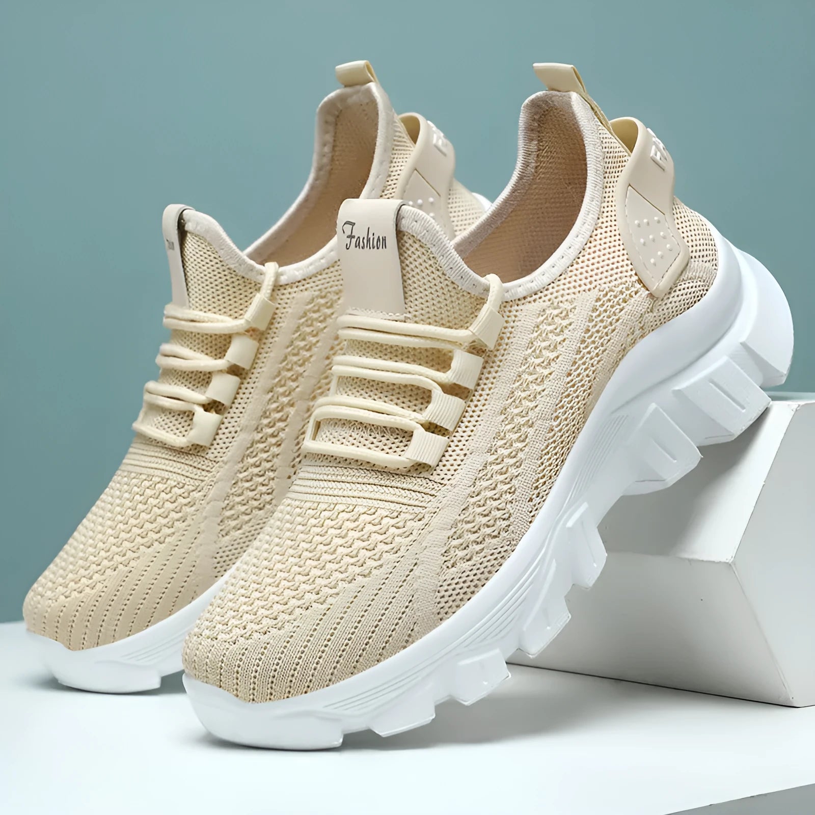Women's white Flyknit sneakers with thick PVC sole and lace-up fastening on a neutral background.