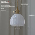 Nordic style bedside chandelier with a glass flower shade in amber, on a white background.