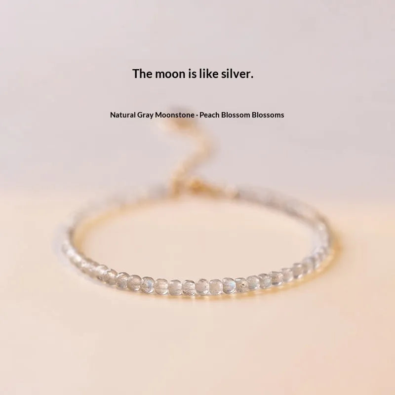 Natural gray moonstone diamond-shaped beads on a silver bracelet with clasp