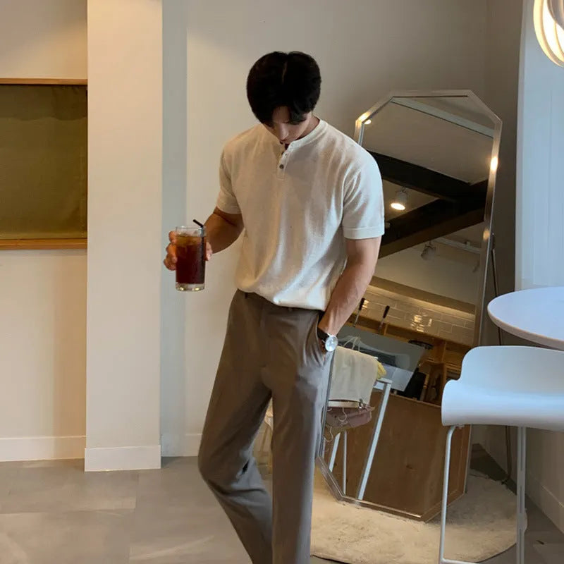 Man wearing a black thin slim-fit ice silk knitted short-sleeved bottoming shirt.