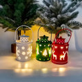 Wrought iron LED candle lantern with flickering light, available in green, white, and red, on a wooden shelf
