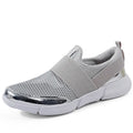 Women's blue low-top casual sneakers with mesh inside on a hard floor surface