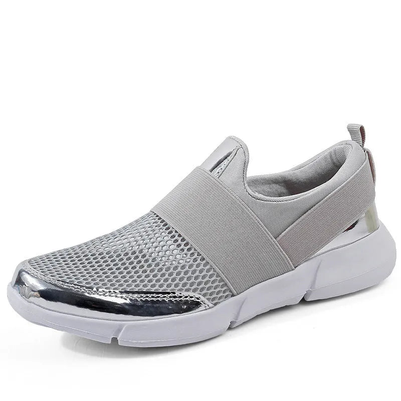 Women's blue low-top casual sneakers with mesh inside on a hard floor surface