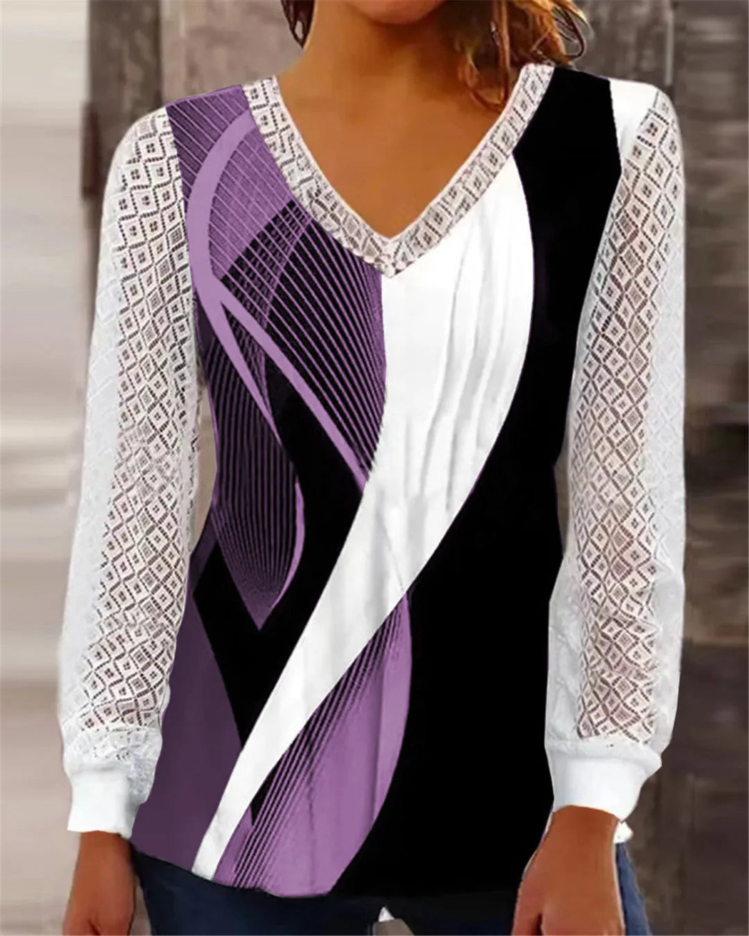 Women's loose purple V-neck pullover top with lace print and long sleeves on a hanger.