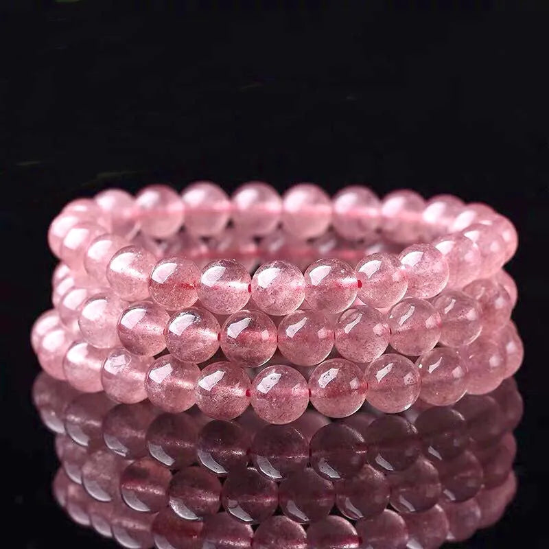 Women's adjustable bracelet with mixed-size polished strawberry quartz crystal beads.