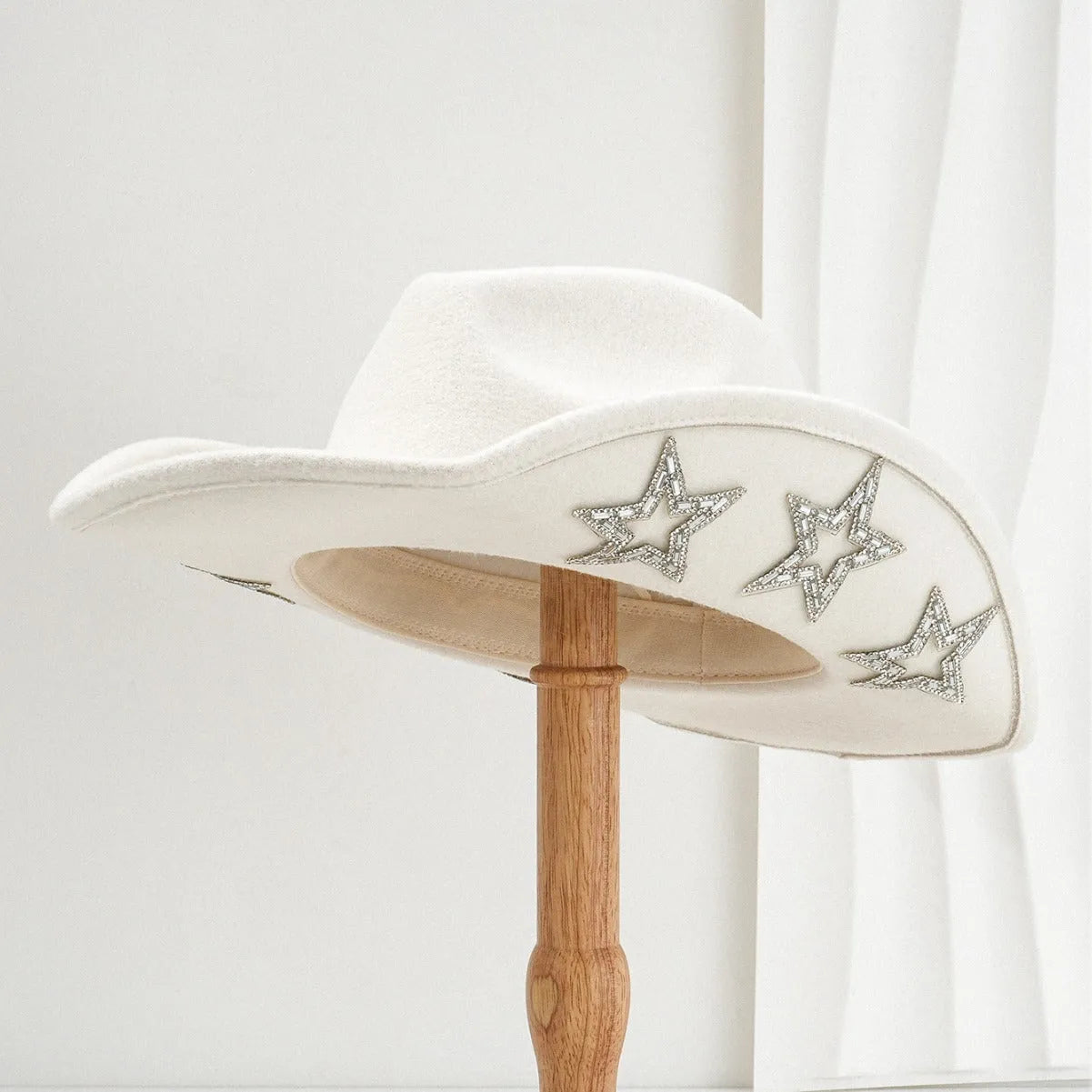 Denim top hat made from woolen felt with a conical crown and hexagonal star decoration.