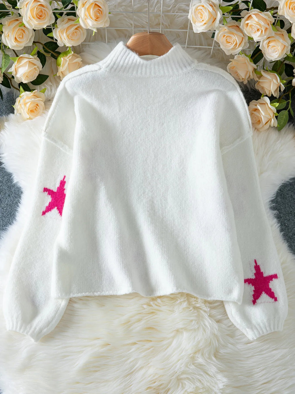 White women's loose turtleneck pullover sweater with a thick imitation velvet fabric and a contrast colour five-pointed star pattern.