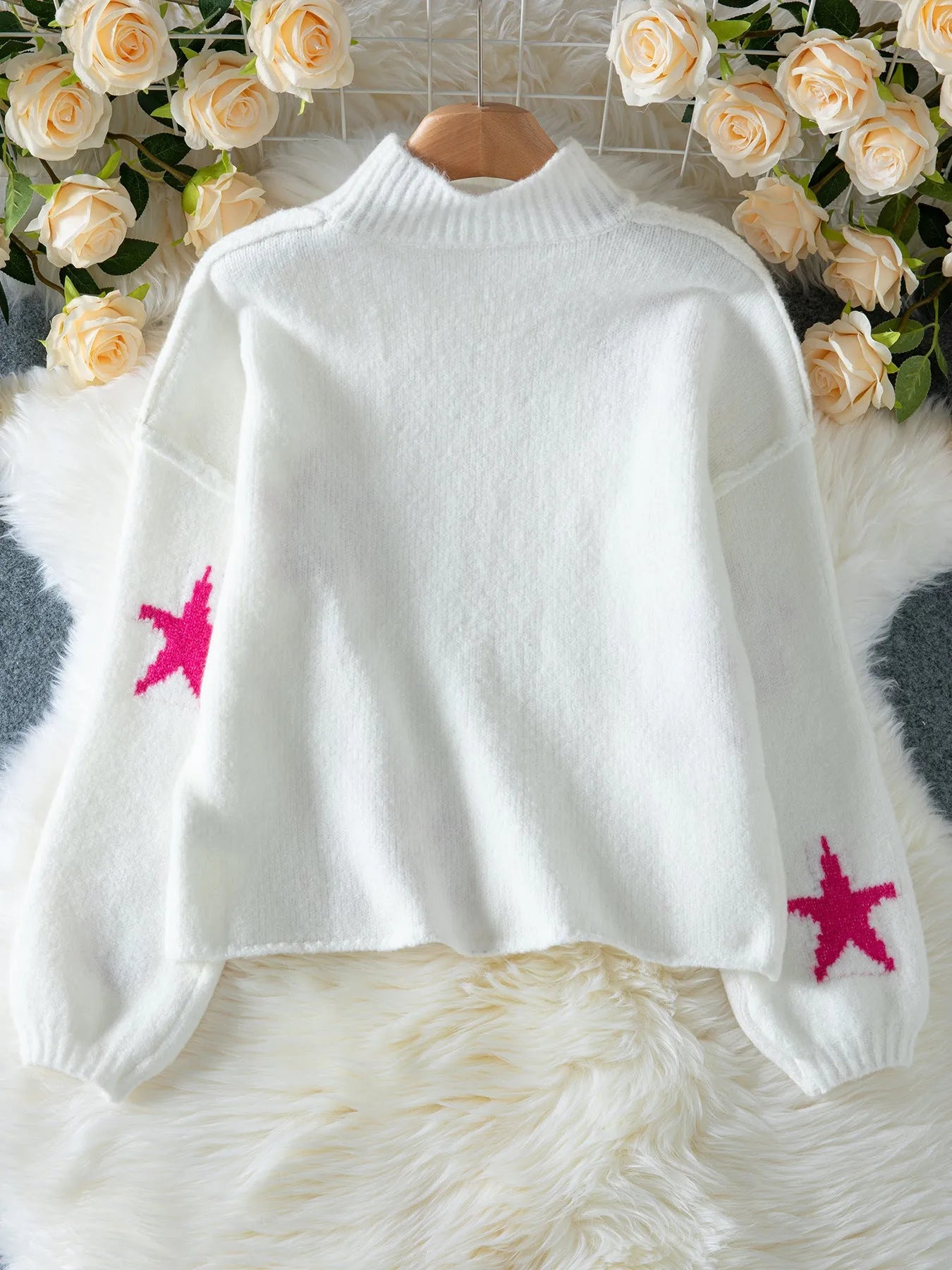 White women's loose turtleneck pullover sweater with a thick imitation velvet fabric and a contrast colour five-pointed star pattern.