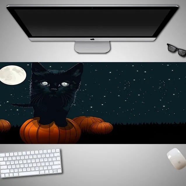 Halloween-themed oversized mouse pad with non-slip rubber cloth backing on a desk