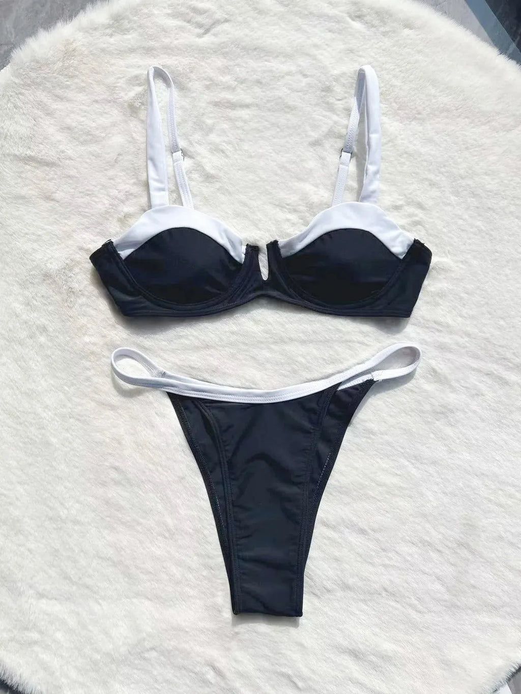 Black low waist women's bikini swimsuit with stitching split detail on the pants.