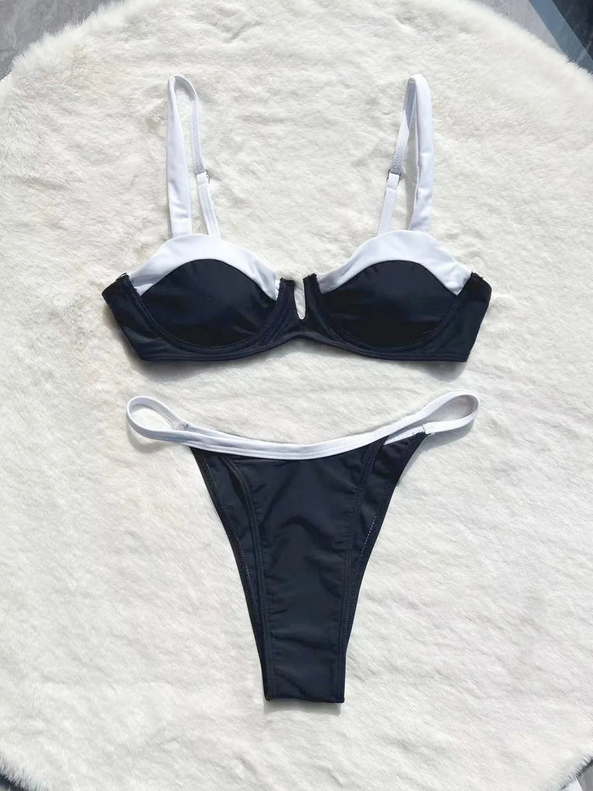 Black low waist women's bikini swimsuit with stitching split detail on the pants.