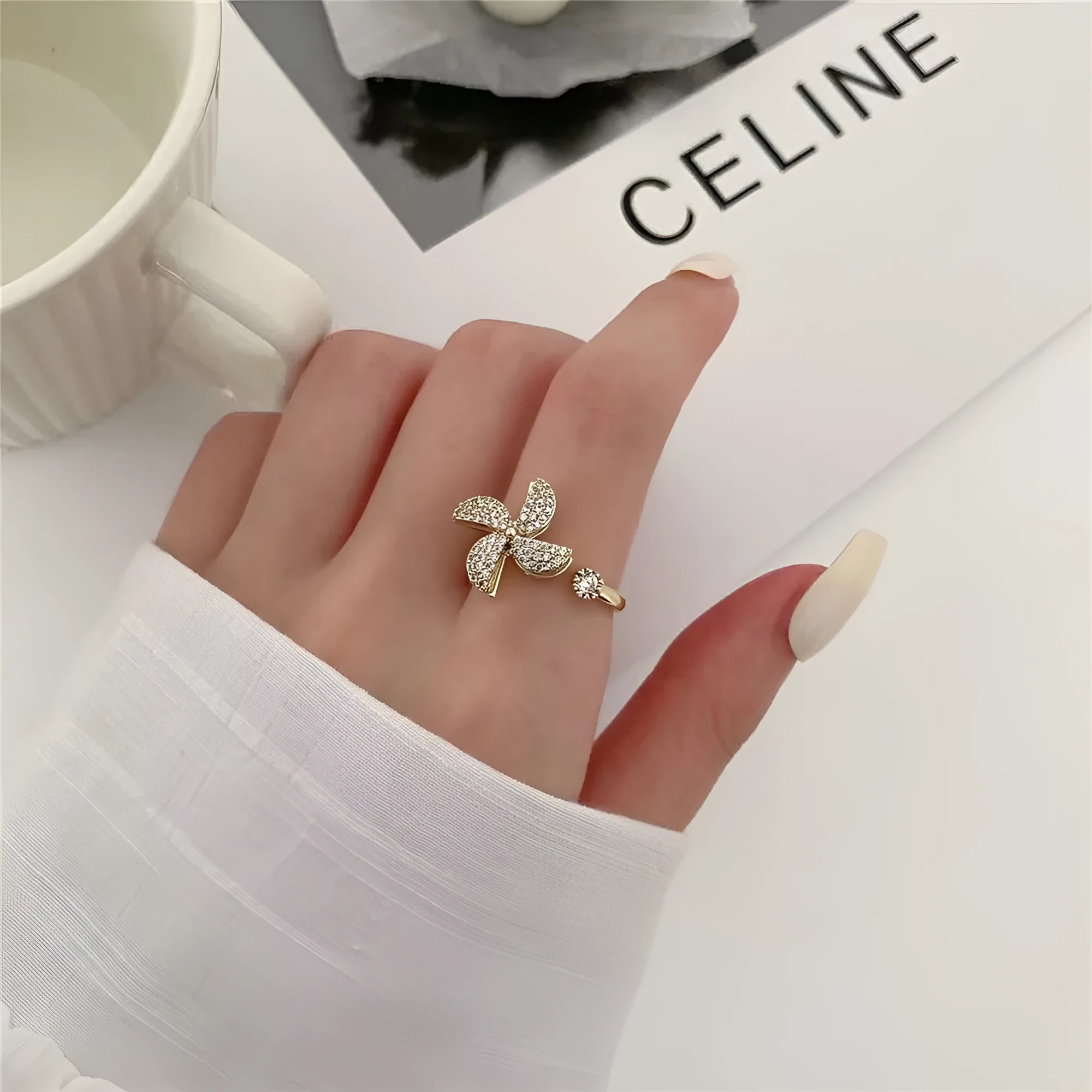Copper ring with a rotating silver windmill design in the centre.