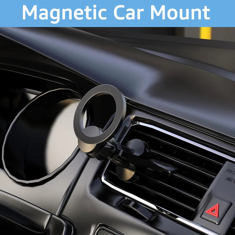 Black magnetic car phone holder clipped to a car air vent with a smartphone attached.