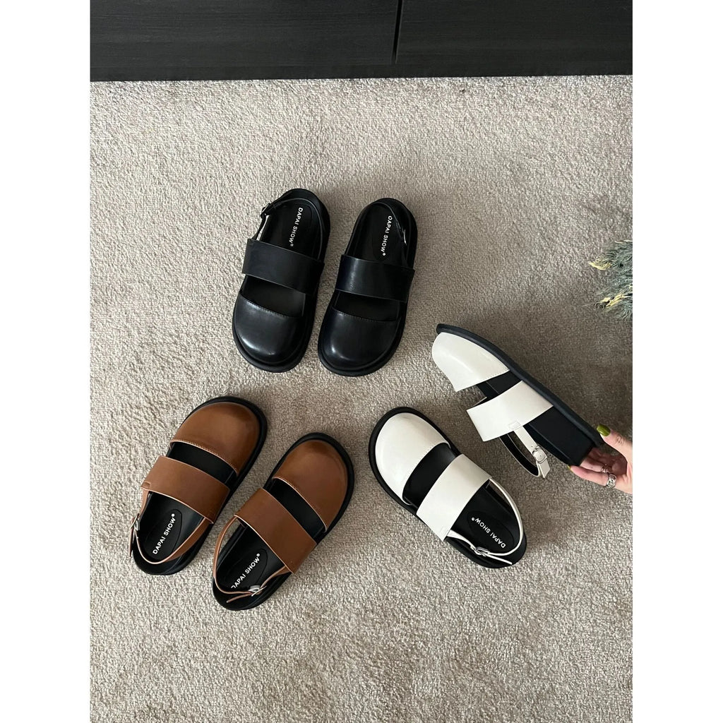 Retro women's sandals with a closed toe, ankle strap buckle, and platform sole in apricot colour.