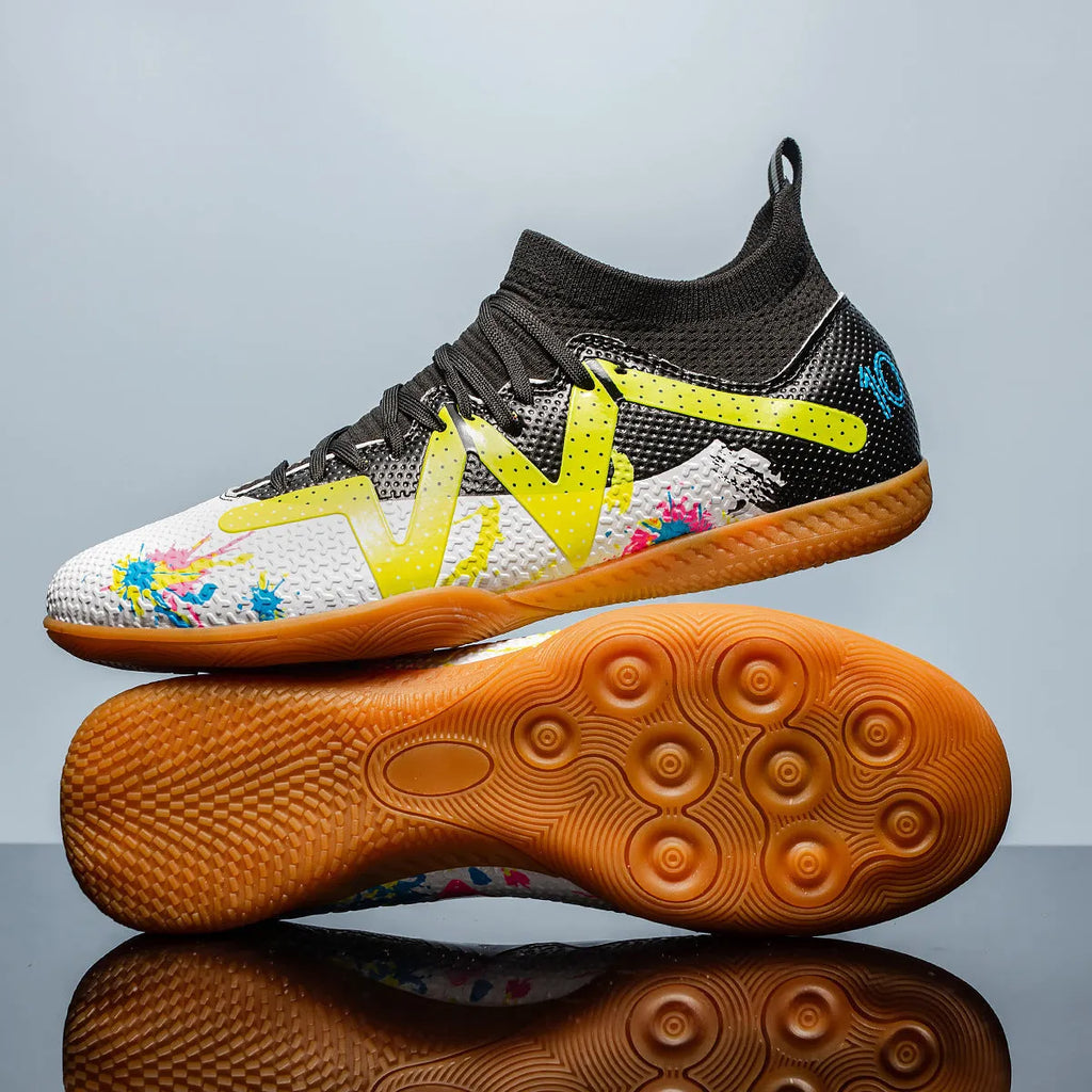 Low-top football shoes in black and yellow colour with PVC upper and rubber sole