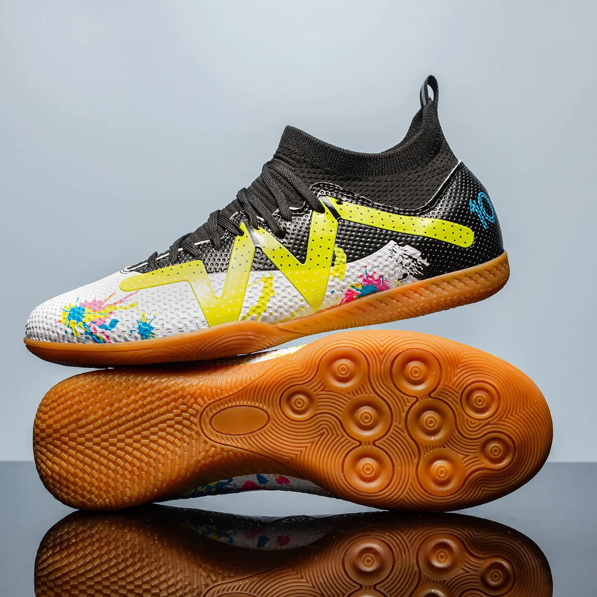 Low-top football shoes in black and yellow colour with PVC upper and rubber sole