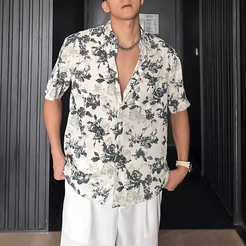 Loose black and white floral print short sleeve casual shirt on a hanger.