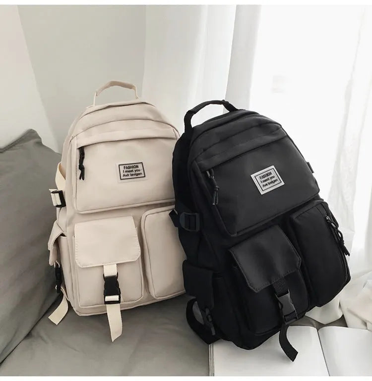 Soft nylon student backpack in black with a three-dimensional front pocket.