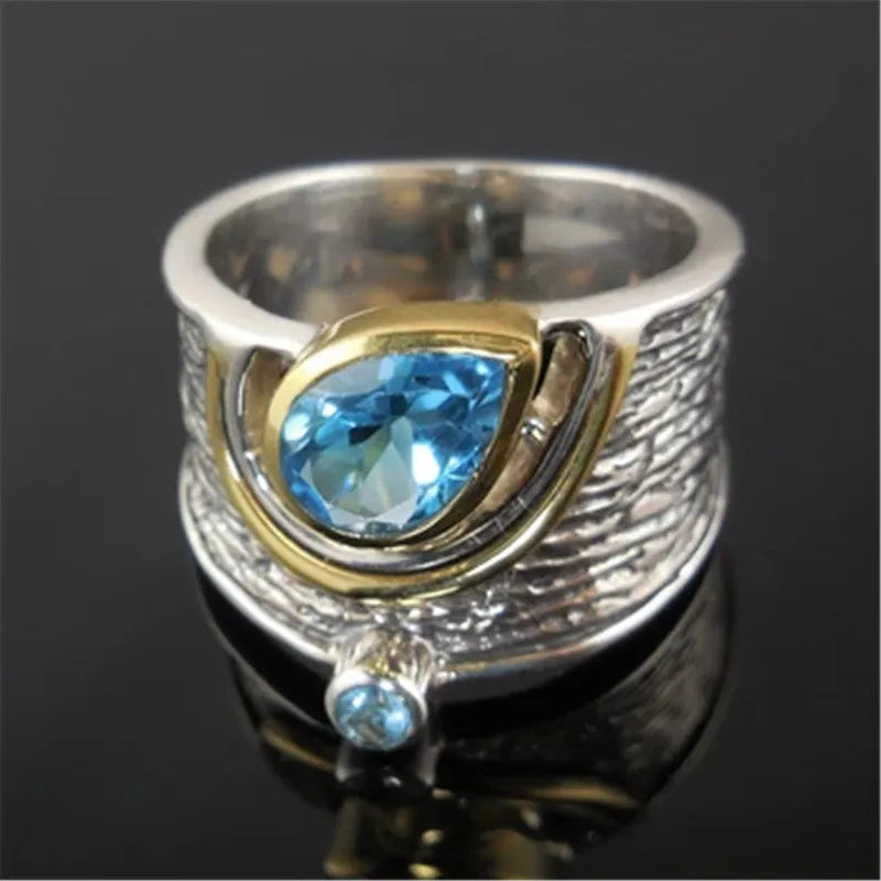 Blue zircon drop shape ring in Creative Chinese Style design, showing inlaid stones on an alloy band.