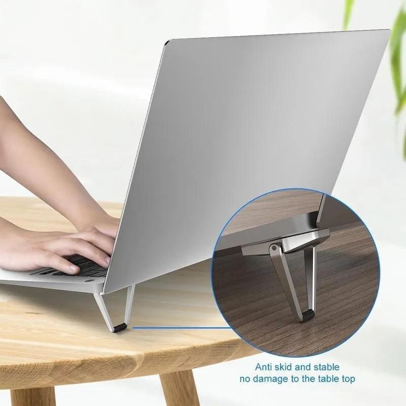 Foldable aluminium laptop bracket in silver colour with compact folded dimensions