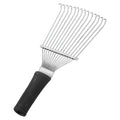 Stainless steel dematting brush rake for grooming horses and pets on a wooden surface.