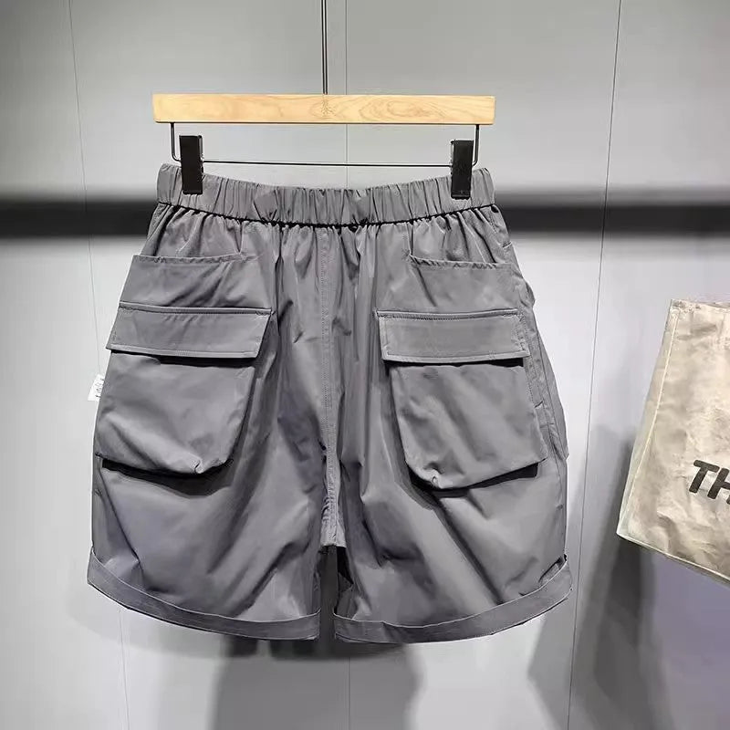 Man wearing large size loose fit black casual shorts with pockets.