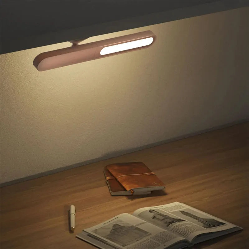 Geometric desk lamp with magnetic base shown in khaki colour with touch control
