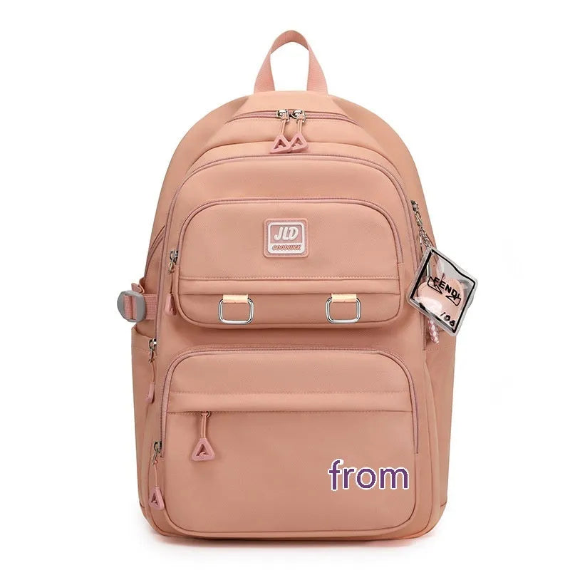 Girls' large purple and pink backpack with physiological curve backboard and geometric pattern.