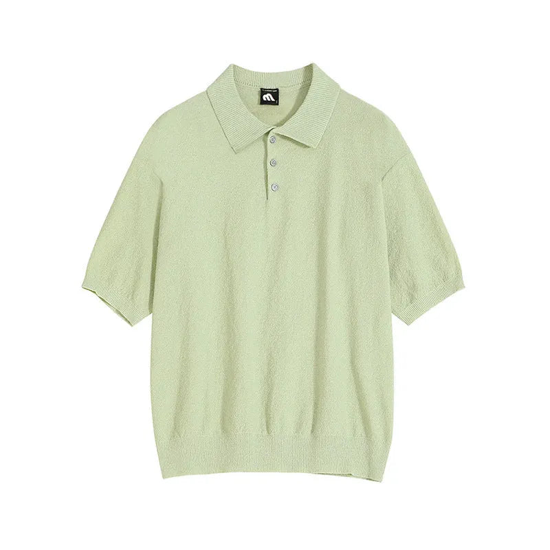 Man wearing a caramel coloured retro knitted polo shirt with short sleeves and an asymmetric design detail.