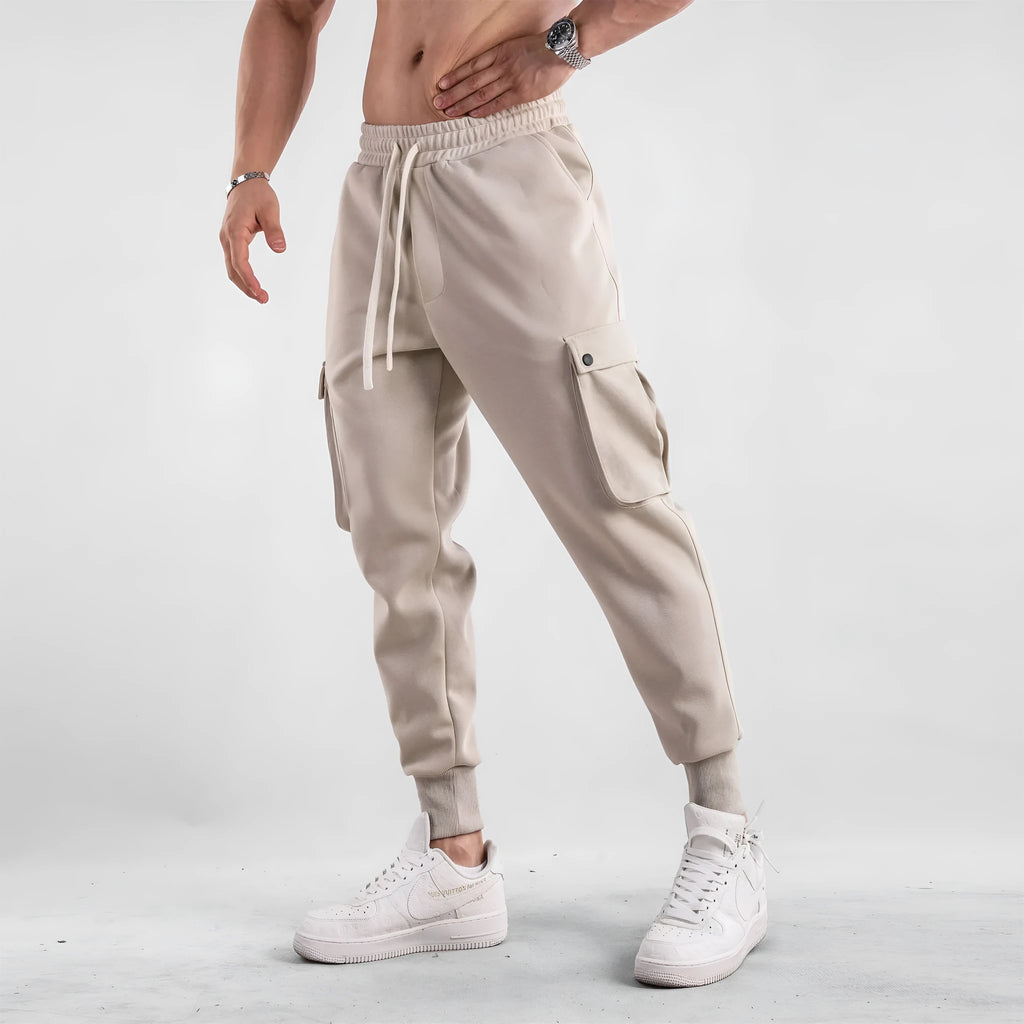 Men's loose fit American sports trousers with ankle ties in apricot colour showing multi-pocket design