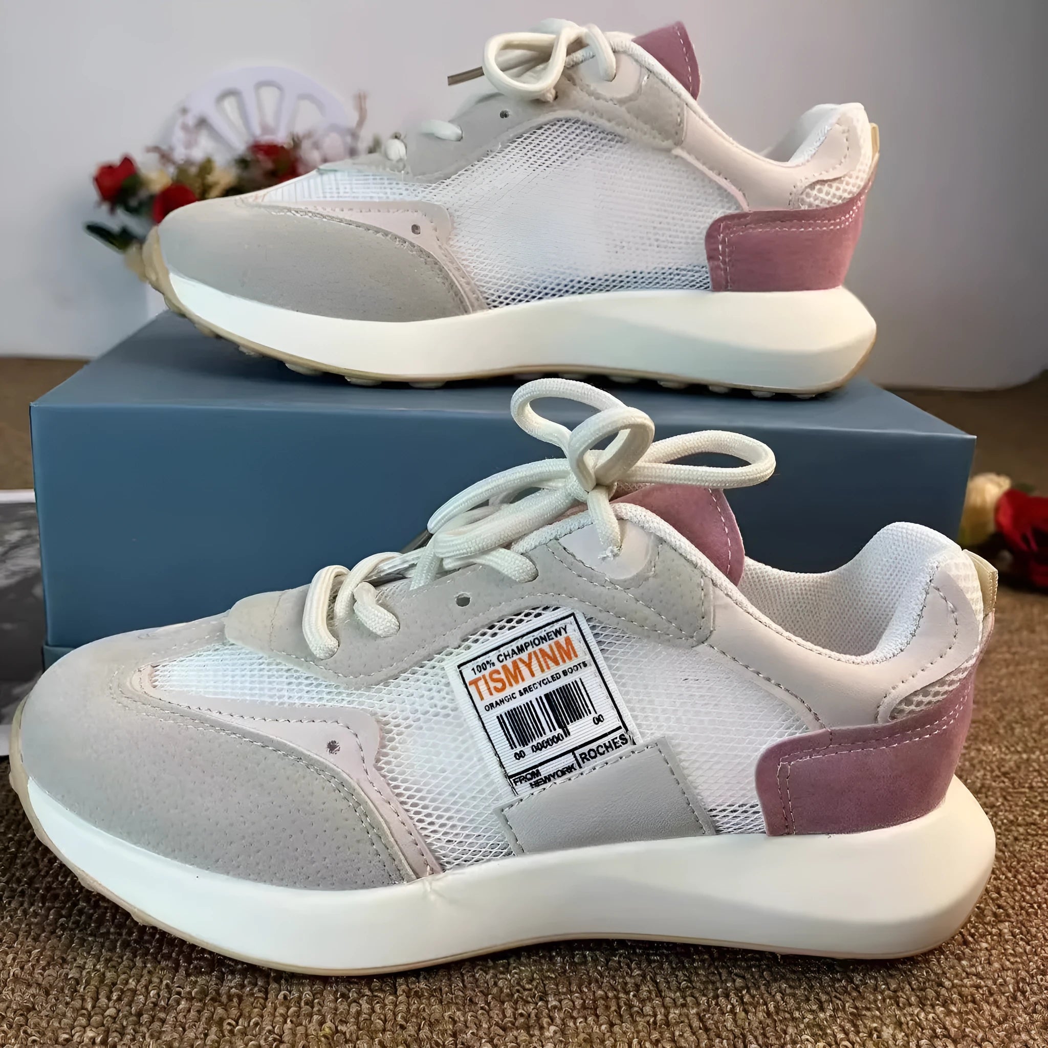 Women's grey retro low-top sneaker with round toe and flat rubber sole on a neutral background.