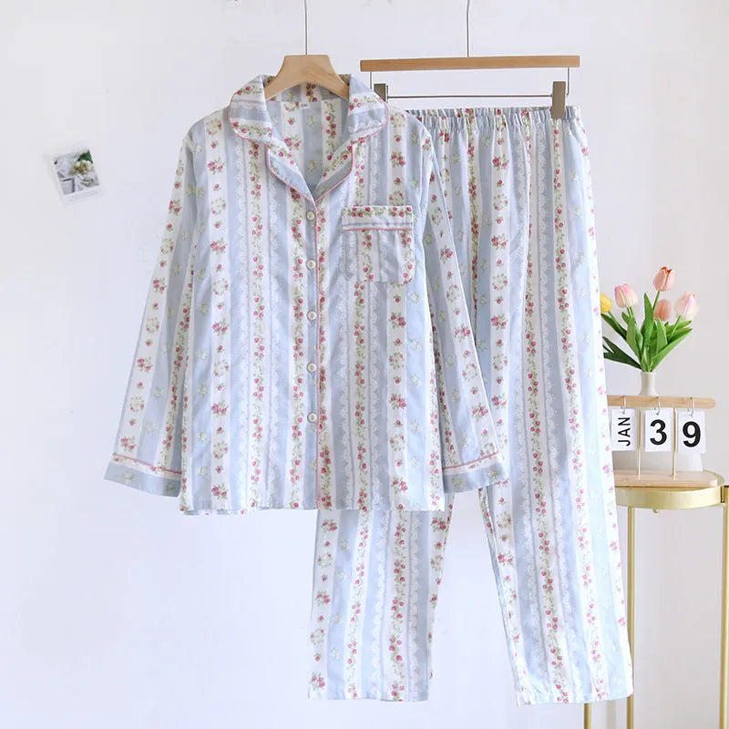 Women's red small fruit print cotton gauze long-sleeved pyjama top and trousers set laid flat.