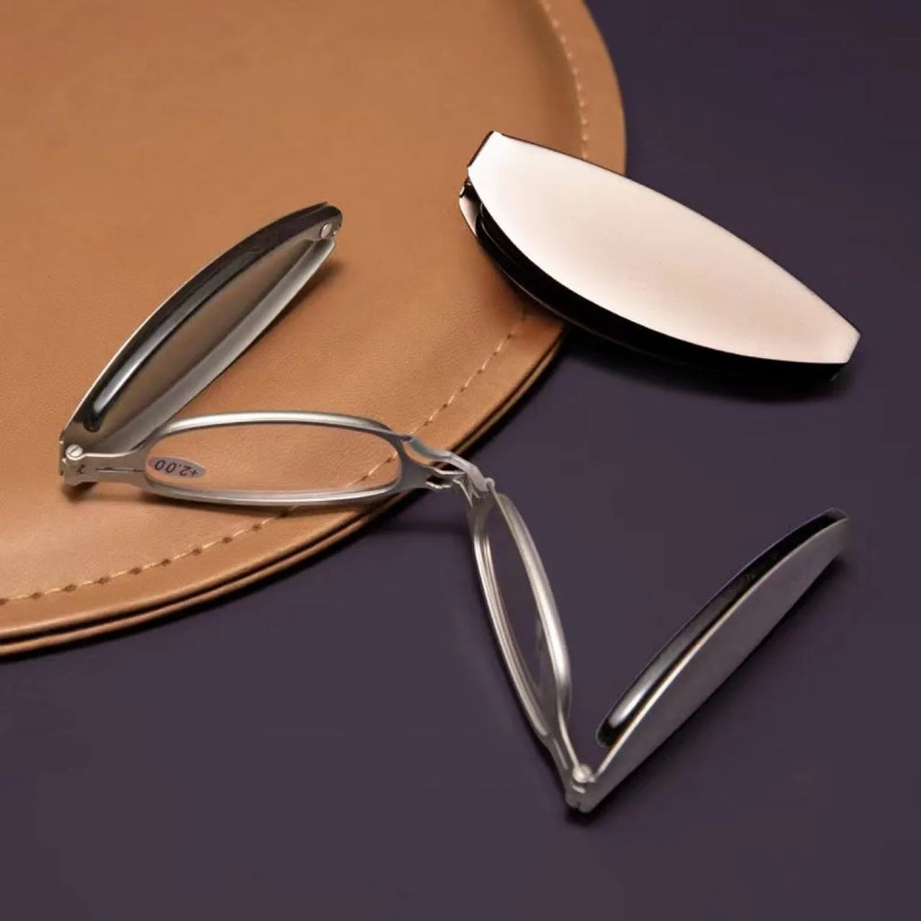 Black retro folding reading glasses with a ring detail, shown in open and closed positions.