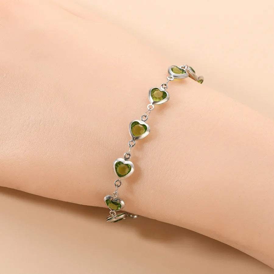Devil's Eye Creative stainless steel heart bracelet in one of six electroplated colours on a wrist.