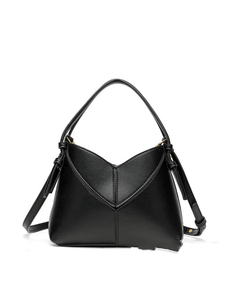 Trendy solid colour stitched oval handbag and crossbody bag for women in black with single shoulder strap and interior slip pocket