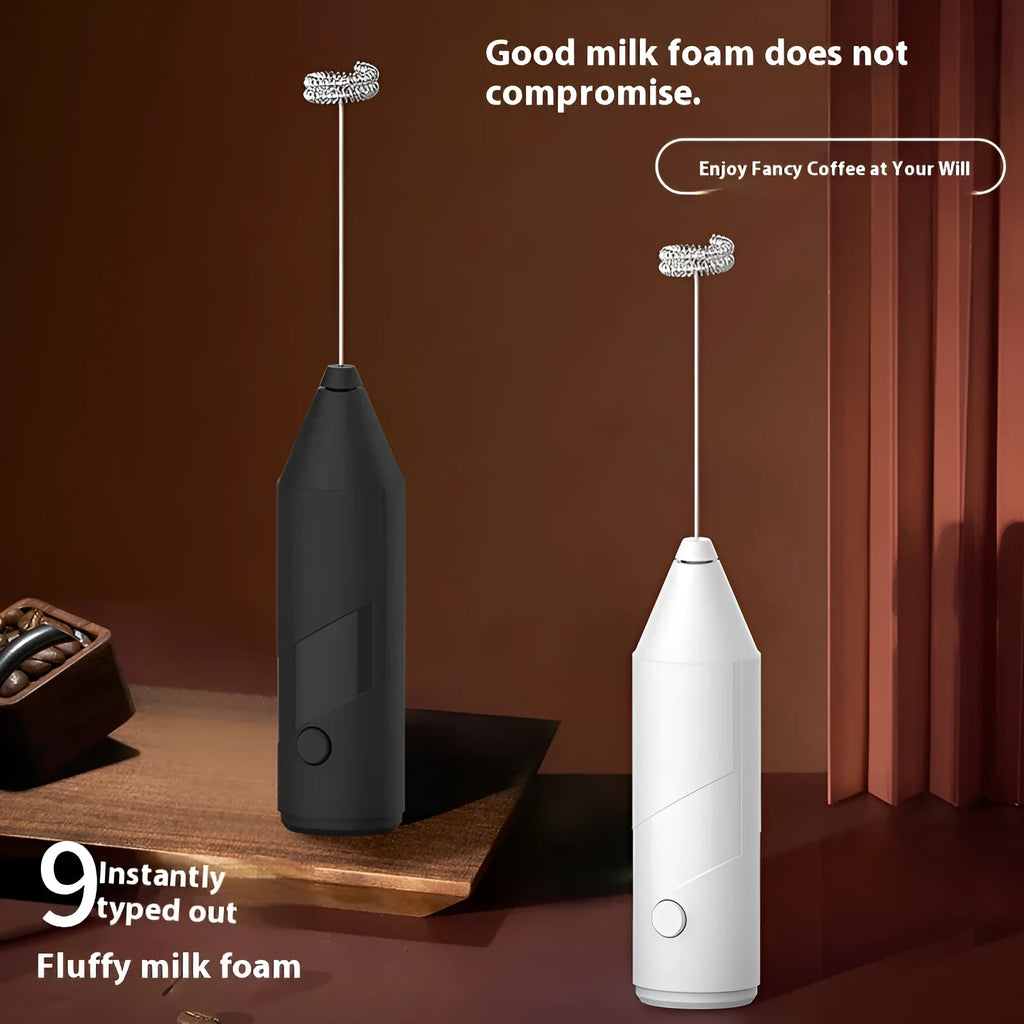 Mini handheld electric milk frother in black, with stainless steel whisk and USB charging cable.