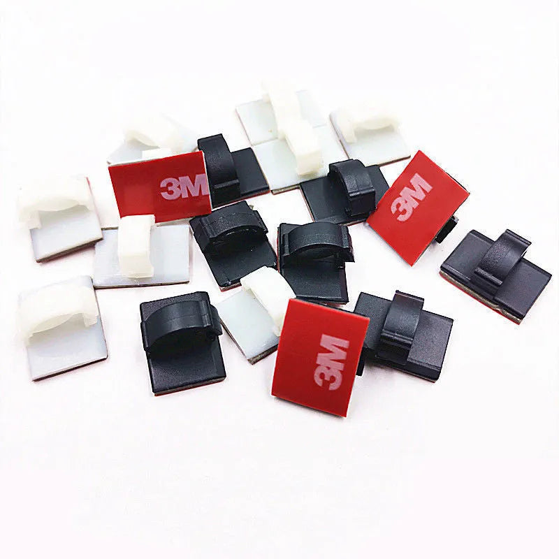 Black self-adhesive flat cable wiring buckle for car wire management on a surface