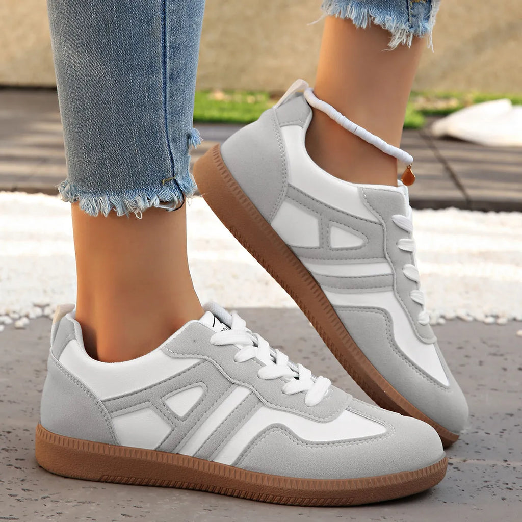 Retro colour-matching lace-up lightweight women's jogging shoes in black, side view showing low top and platform sole