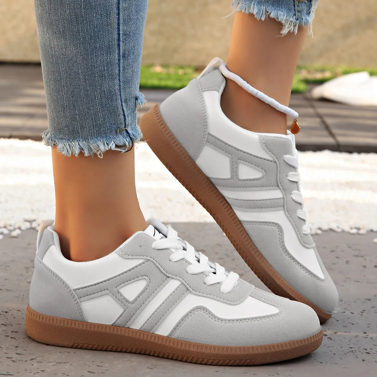 Retro colour-matching lace-up lightweight women's jogging shoes in black, side view showing low top and platform sole