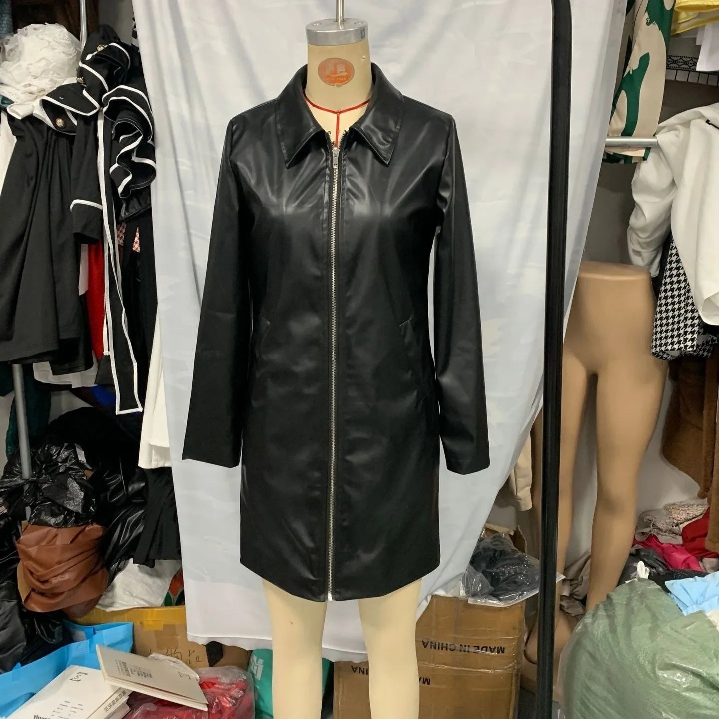 Women's black polyester jacket with long sleeves, medium 65cm length, casual commute style, front view