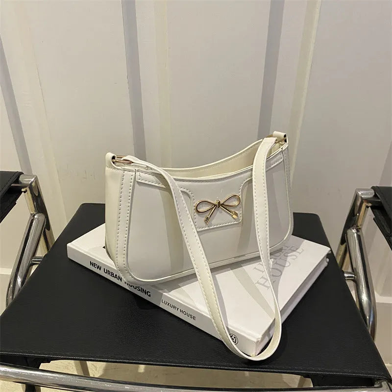 Portable shoulder western style bagg bag in PU with bow accent, available in six colours, 24x14x5 cm