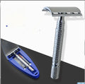 Chrome double edged safety razor with brass handle and closed comb head on storage box.
