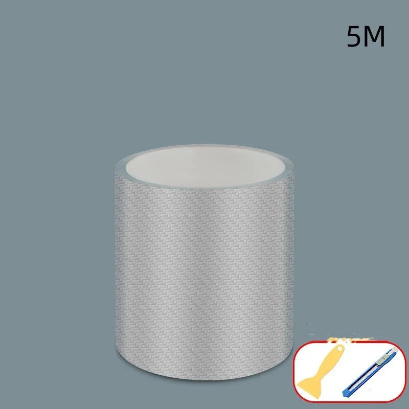 Roll of carbon fibre car door edge protection strip in clear carbon grain finish with scraper and utility knife